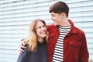 teenage couple in love looking into each others eyes photo