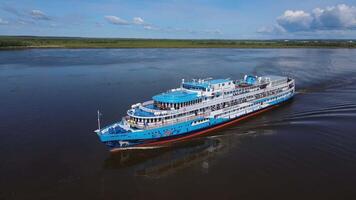 Aerial. A motor ship on the background of a bridge sails on the river video