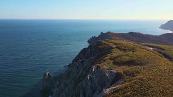 A scenic overlook of a cliff by the ocean with endless water and sky views video