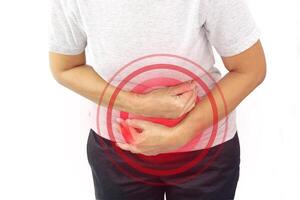 Asian woman suffering from stomachache with clipping path. Chronic gastritis, menstruation and health concept. photo