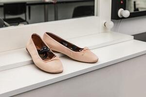 Women's dancing shoes stand on the table photo