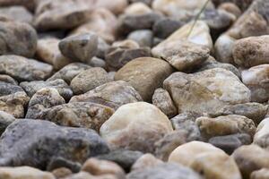 Picture on a floor consisting of different sized and colored stones photo