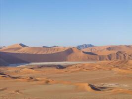 Drone panorama over the Sossusvlei and the surrounding dunes of the Namib Desert in Namibia during the day photo