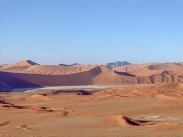 Drone panorama over the Sossusvlei and the surrounding dunes of the Namib Desert in Namibia during the day photo