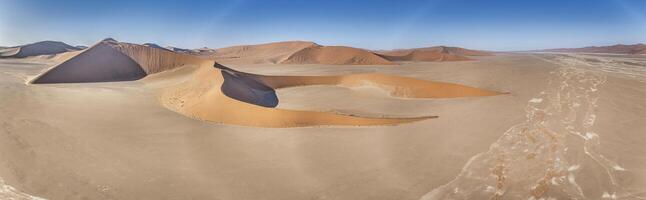 Drone panorama over the Sossusvlei and the surrounding dunes of the Namib Desert in Namibia during the day photo