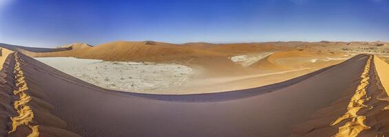 Panoramic view from the Big Daddy Dune in Sussusvlei onto the salt pan of Deathvlei with surrounding red dunes in the morning photo