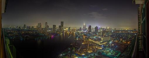 View over Bangkok at night with the Chao Phraya River photo