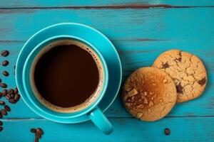 Coffee cup and cookie chocolate on blue wooden background.. photo