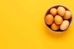 Top view raw eggs on yellow background.. photo