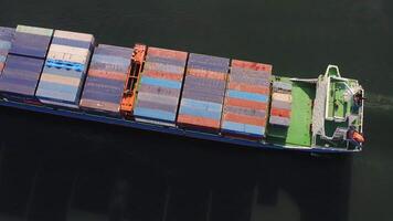 Aerial top-down view of a passing container ship with a cargo of containers video