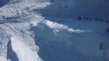 Aerial. A skier descends at high speed down an unprepared slope video