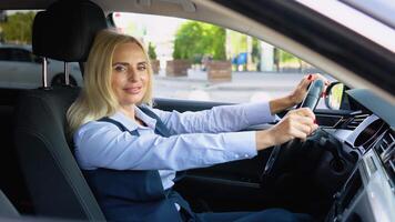 Portrait of a confident woman sitting in a car in a business suit near a modern office building video