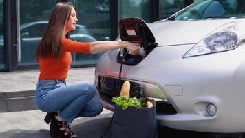 A girl cannot get the charger of her electric car video