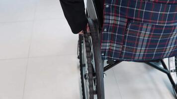 Businesswoman in wheelchair in office corridor. Business people in office concept video