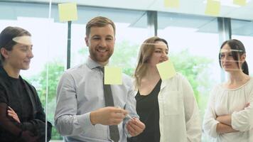 Group of young entrepreneurs discussing business in company meeting room video