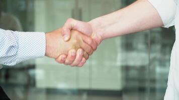Close up two men shake hands, conclude successful contract agreement, sign of support for partnership cooperation video