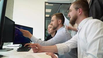 Confident smart manager explaining corporate software details to motivated colleagues. Smiling employees listening to leader instructions video