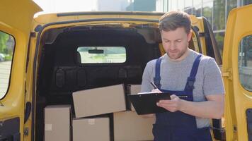 Delivery man writing something to clipboard. Delivery of medicines and products video