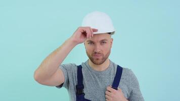 Serviceman in overalls putting on a helmet video