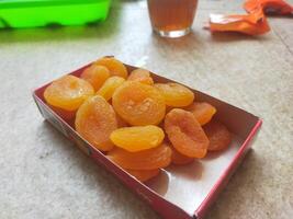 Dried Apricots in paper box container photo