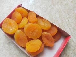 Dried Apricots in paper box container photo