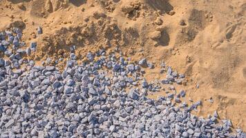 Construction material background texture of medium sand and flake stone on the ground, top view with copy space photo