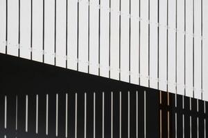 Abstract pattern background of white wooden Trellis roof awning with shadow on house wall surface photo