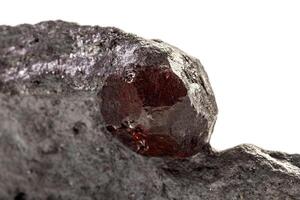 Macro mineral stone Garnet in rock on a white background photo