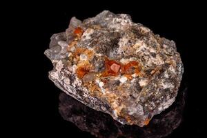 macro mineral stone Grossular, Garnet, Epidote on a black background photo