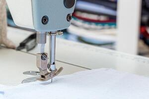 Sewing machine needle with thread and fabric photo