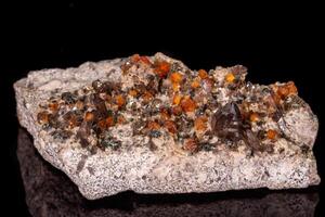 macro mineral stone Grossular, Garnet, Epidote on a black background photo