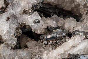 Macro mineral stone Stibnite quartz on a black background photo