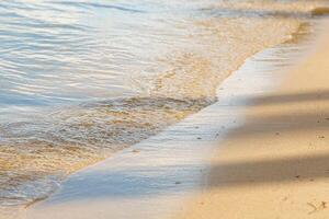 beautiful beach yellow sand with sea waves photo