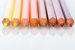 red, pink, yellow pencil on a white background photo