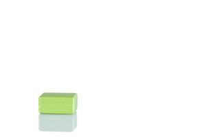 Wooden cube of green color on a white background photo