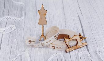 sewing tape, sewing machine and wood mannequin photo