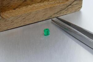 macro mineral faceted stone Emeralds on a gray background photo