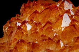 Macro mineral stone Citrine in rock in crystals on a black background photo