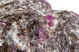 Macro of a mineral Ruby stone on a white background photo