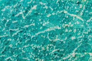 Macro of mineral stone amazonite on white background photo