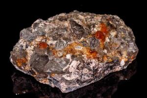 macro mineral stone Grossular, Garnet, Epidote on a black background photo