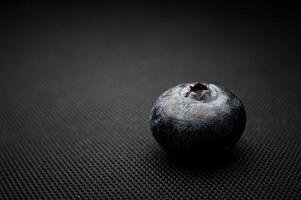 One blueberry black background. Very detailed macro shoot with copy space photo