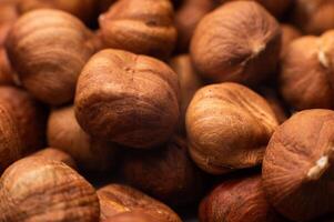 Close-up of Hulled whole cobalt or hazelnut seeds of Corylus avellana. Macro photo of food, close up from above