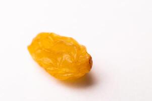 macro photography of raisins on a white background, side view. close-up of one piece of raisin photo