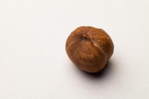 Hazelnut. Fresh organic peeled hazelnuts on a white background. Macro shot of a nut photo