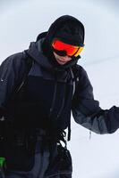 Portrait of a skier in safe ski equipment, standing and relaxing smiling while on vacation on the ski slope photo