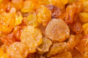 Background of a large number of dried yellow golden grapes. Raisin. Vegetarian diet photo