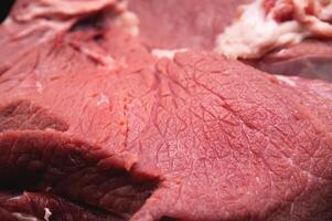 Close-up of a piece of fresh beef meat in shallow depth of field photo