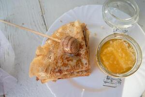 ruso panqueques con miel y un taza de té desde un Clásico Samovar maslenitsa festival concepto foto