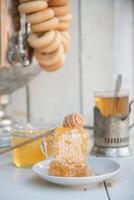 honeycomb with honey on a saucer and tea from a Russian samovar with bagels, Slavic tea party photo